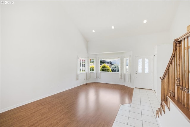 1825 Minnesota St, The Dalles, OR 97058 - entryway with light wood finished floors, a healthy amount of sunlight, high vaulted ceiling, and stairway