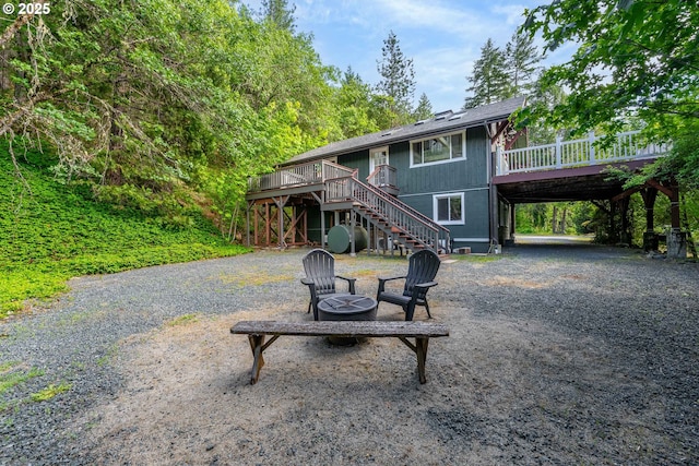988 Savage Creek Rd, Grants Pass, OR 97527 - view of front of property with stairway, a wooden deck, a fire pit, and driveway