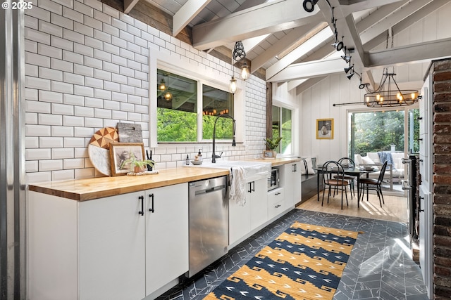 988 Savage Creek Rd, Grants Pass, OR 97527 - kitchen featuring butcher block countertops, dishwasher, plenty of natural light, and white cabinets