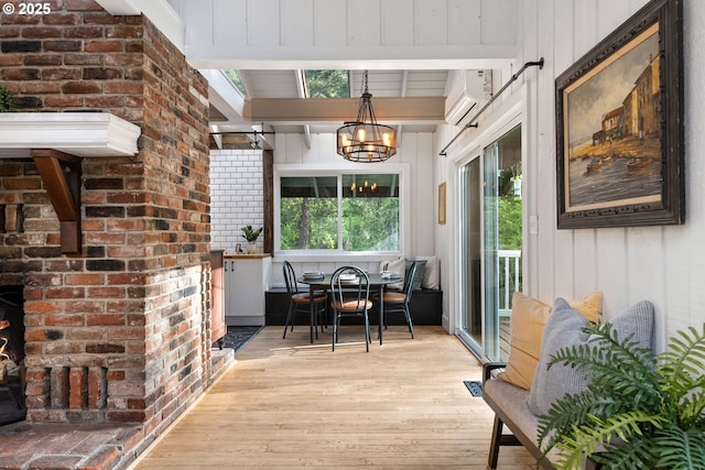 988 Savage Creek Rd, Grants Pass, OR 97527 - dining space featuring light wood-style flooring, a chandelier, a wall mounted AC, and beamed ceiling