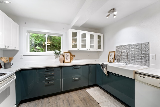 988 Savage Creek Rd, Grants Pass, OR 97527 - kitchen with white appliances, glass insert cabinets, light wood-type flooring, a sink, and white cabinets