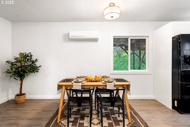 988 Savage Creek Rd, Grants Pass, OR 97527 - dining room featuring a wall unit AC, wood finished floors, and baseboards