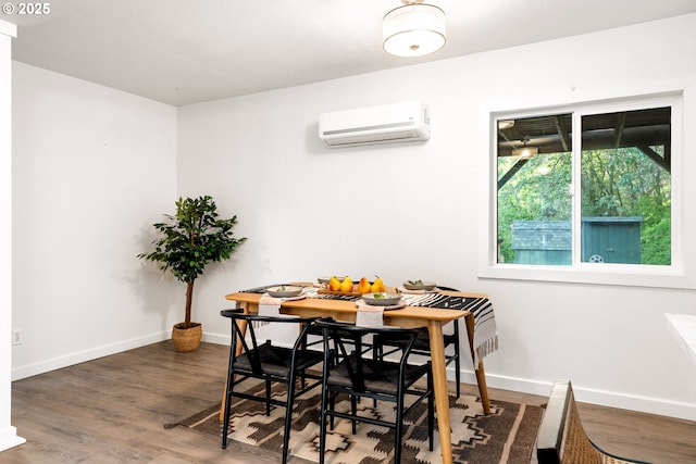 988 Savage Creek Rd, Grants Pass, OR 97527 - dining area featuring a wall mounted AC, wood finished floors, and baseboards