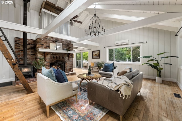 988 Savage Creek Rd, Grants Pass, OR 97527 - living room with a wall mounted AC, hardwood / wood-style floors, beamed ceiling, baseboards, and ceiling fan