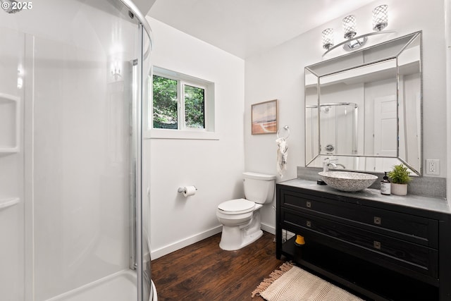 988 Savage Creek Rd, Grants Pass, OR 97527 - full bath featuring vanity, a stall shower, toilet, wood finished floors, and baseboards