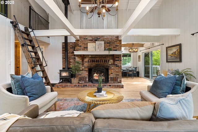 988 Savage Creek Rd, Grants Pass, OR 97527 - living area with high vaulted ceiling, a chandelier, wood finished floors, beam ceiling, and wood walls