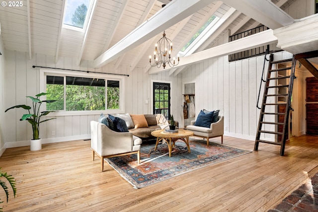 988 Savage Creek Rd, Grants Pass, OR 97527 - living area with a skylight, wood-type flooring, stairway, a chandelier, and wood walls