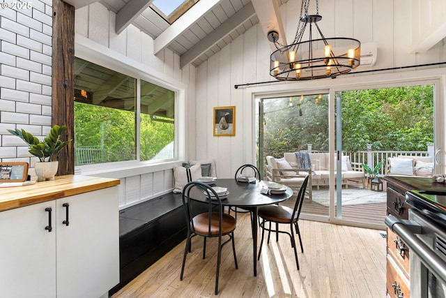 988 Savage Creek Rd, Grants Pass, OR 97527 - dining area with light wood-style flooring, a chandelier, and wood walls