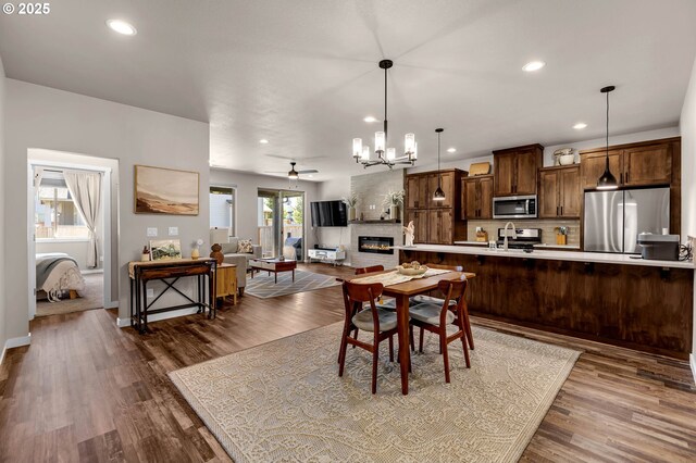 13009 NE 106th Cir, Vancouver, WA 98682 - dining area featuring recessed lighting, a chandelier, dark wood-type flooring, a ceiling fan, and baseboards