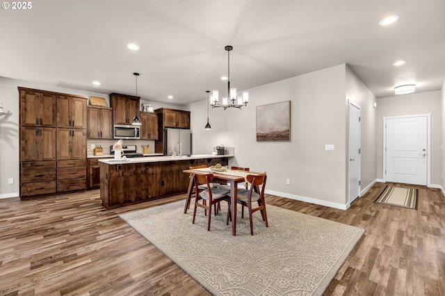 13009 NE 106th Cir, Vancouver, WA 98682 - dining area featuring wood finished floors, baseboards, a chandelier, and recessed lighting