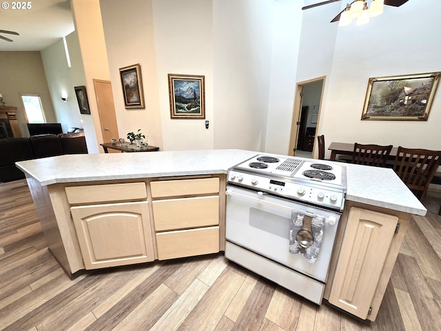 80393 Zimmer Ln, Hermiston, OR 97838 - kitchen with electric range, ceiling fan, a towering ceiling, light countertops, and open floor plan