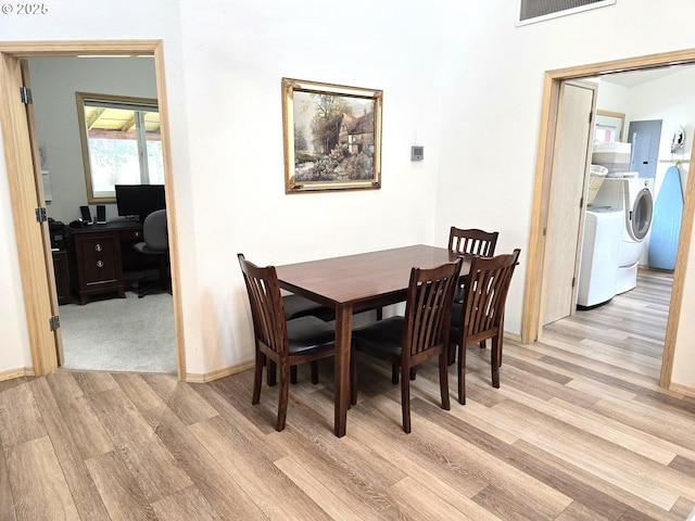 80393 Zimmer Ln, Hermiston, OR 97838 - dining space featuring light wood-style flooring, washer and dryer, electric panel, an office area, and baseboards
