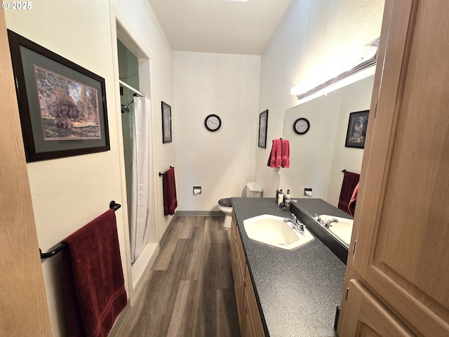 80393 Zimmer Ln, Hermiston, OR 97838 - bathroom featuring wood finished floors, a shower, toilet, and vanity