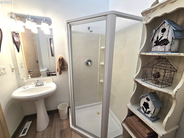 80393 Zimmer Ln, Hermiston, OR 97838 - bathroom featuring a stall shower, wood finished floors, and baseboards