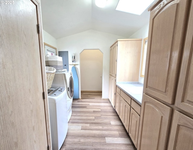 80393 Zimmer Ln, Hermiston, OR 97838 - laundry room featuring cabinet space, washer and dryer, light wood-type flooring, electric panel, and a skylight