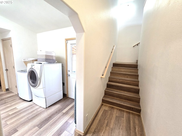 80393 Zimmer Ln, Hermiston, OR 97838 - washroom with washing machine and clothes dryer, light wood-style floors, and arched walkways