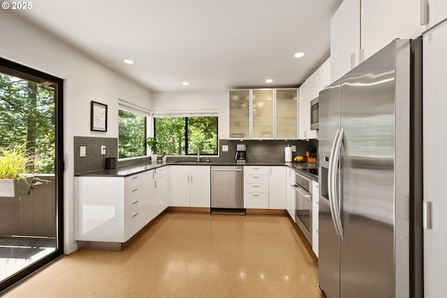 160 Iron Mountain Blvd, Lake Oswego, OR 97034 - kitchen with appliances with stainless steel finishes, decorative backsplash, dark countertops, glass insert cabinets, and recessed lighting