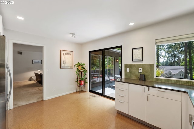 160 Iron Mountain Blvd, Lake Oswego, OR 97034 - kitchen with freestanding refrigerator, plenty of natural light, white cabinetry, dark countertops, and recessed lighting