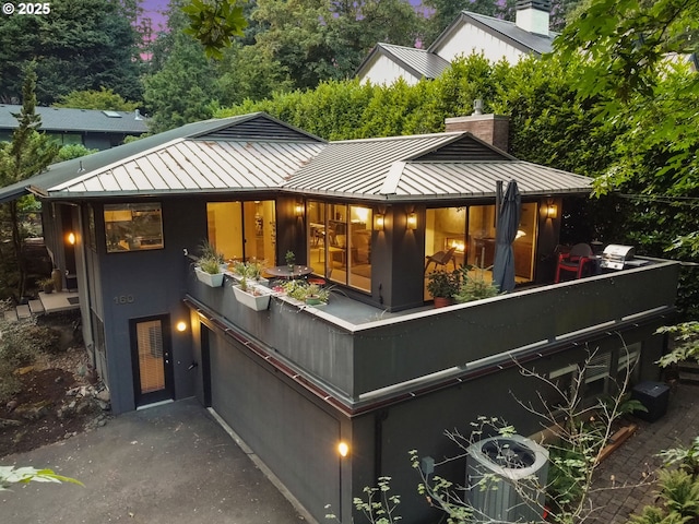 160 Iron Mountain Blvd, Lake Oswego, OR 97034 - back of house with a standing seam roof, a metal roof, and a chimney