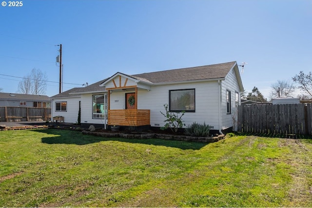 view of front of home with a front lawn and fence