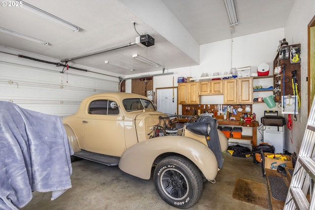 garage featuring a workshop area and a garage door opener