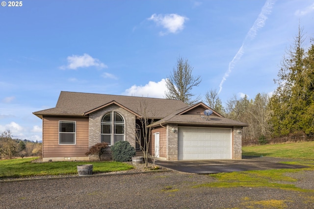 view of front of property with a garage and a front lawn