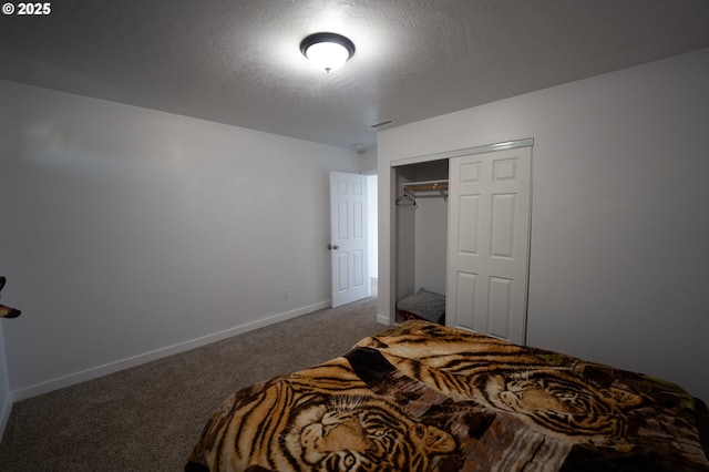 carpeted bedroom with a textured ceiling, a closet, baseboards, and visible vents