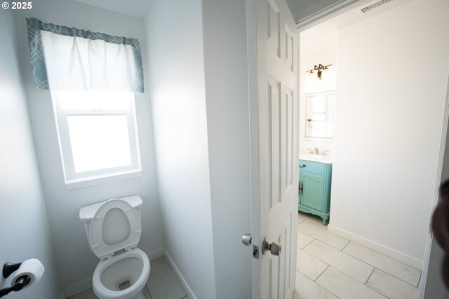 bathroom with tile patterned floors, vanity, visible vents, and toilet