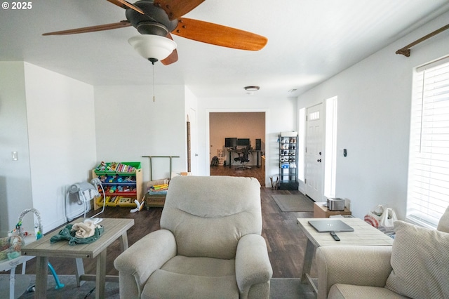 living room featuring dark wood-style floors and a ceiling fan