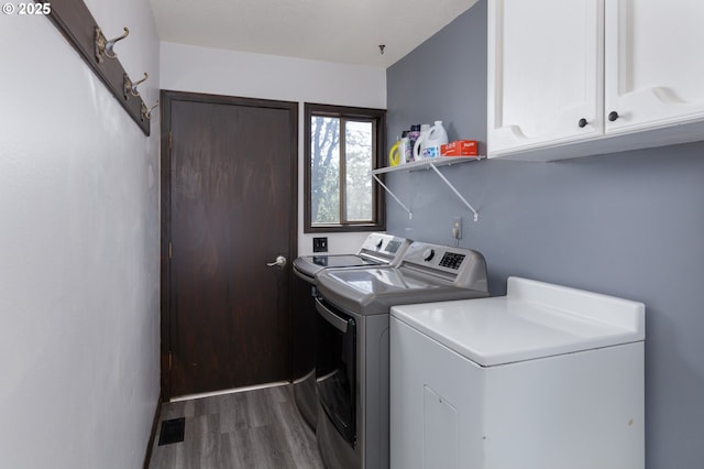 78902 Walters Rd, Maupin, OR 97037 - laundry area with washing machine and dryer, cabinet space, and wood finished floors