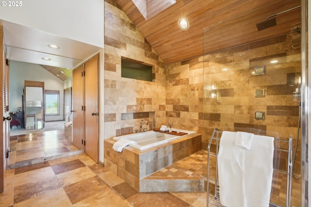 bathroom with a garden tub, wood ceiling, vaulted ceiling, and tile walls