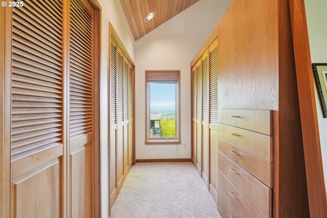 corridor featuring light carpet, recessed lighting, baseboards, vaulted ceiling, and wood ceiling
