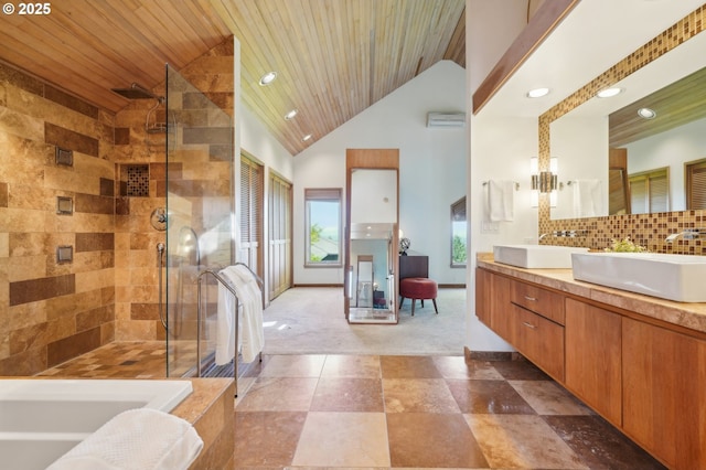 bathroom featuring a sink, a tile shower, recessed lighting, and a bath