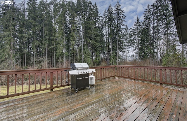 wooden deck featuring a grill