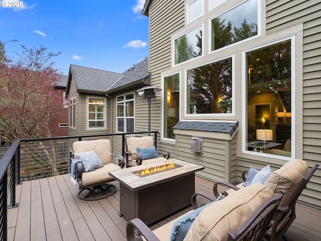 wooden terrace featuring an outdoor fire pit