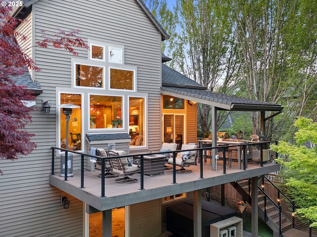 deck with outdoor dining area and stairs