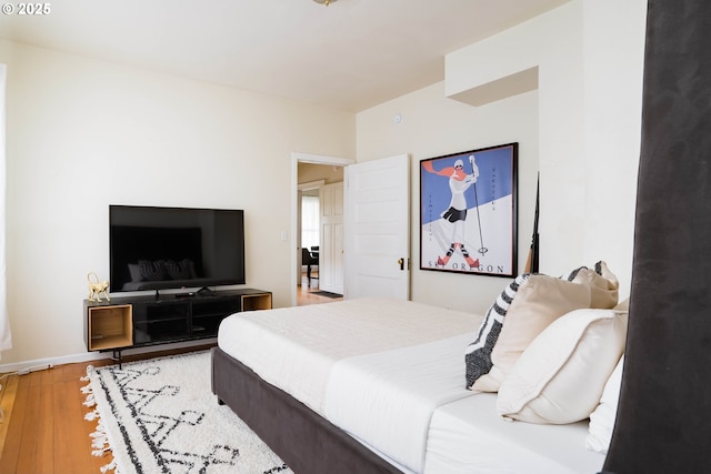 bedroom with hardwood / wood-style flooring