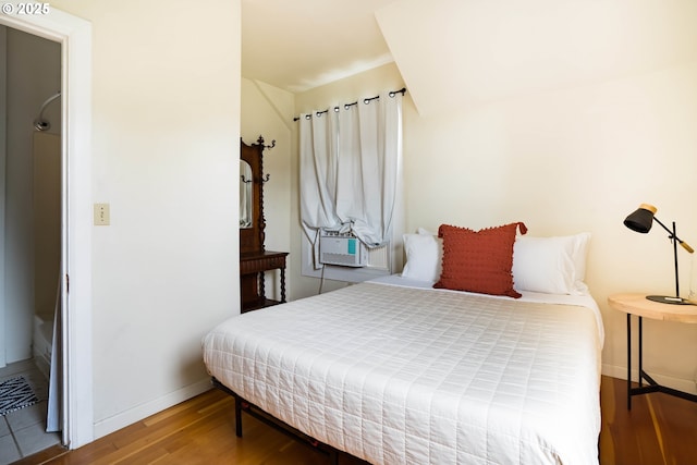 bedroom featuring hardwood / wood-style flooring and cooling unit