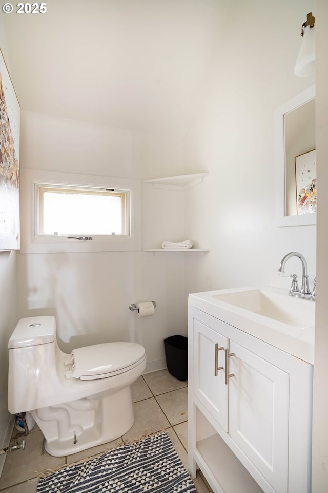 bathroom with tile patterned floors, vanity, and toilet