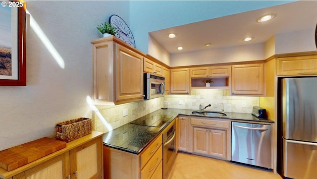 kitchen featuring a sink, recessed lighting, decorative backsplash, and appliances with stainless steel finishes