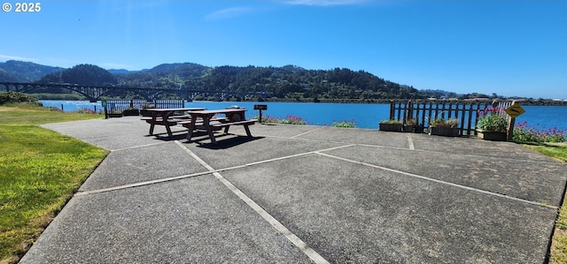 exterior space with a water and mountain view