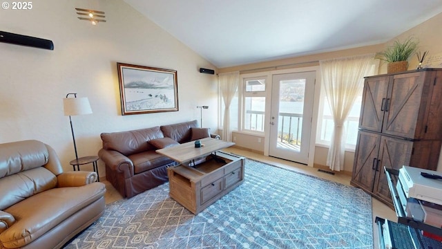 living room featuring visible vents and vaulted ceiling