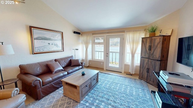 living room with lofted ceiling, visible vents, and light colored carpet