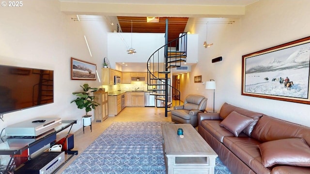 living area featuring stairway and a towering ceiling