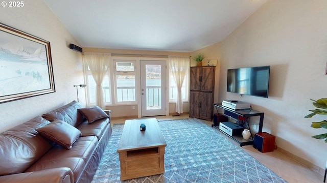 carpeted living room with vaulted ceiling and baseboards