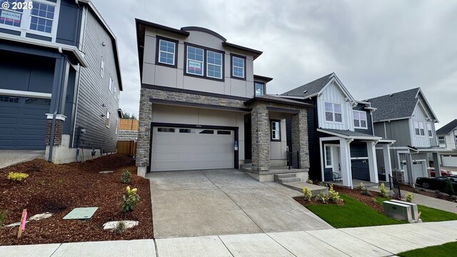 11714 SW 178th Dr, Beaverton, OR 97007 - view of front of home with concrete driveway, stone siding, board and batten siding, an attached garage, and stucco siding