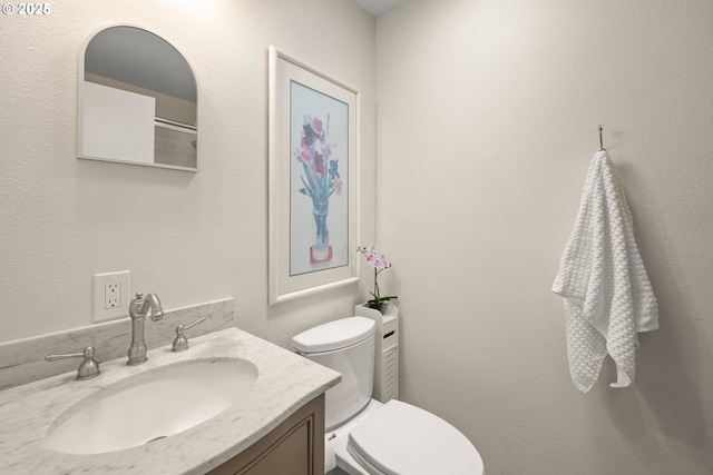 bathroom with toilet and vanity