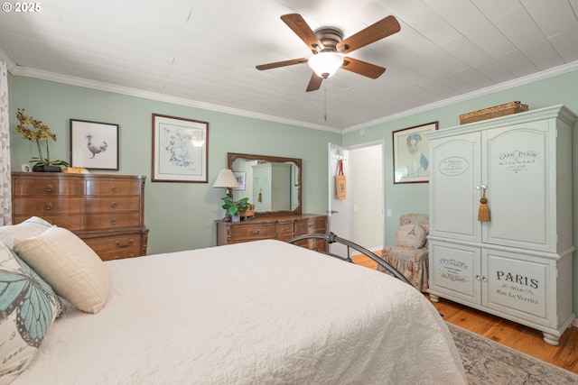 bedroom with ceiling fan, light wood-style flooring, and crown molding