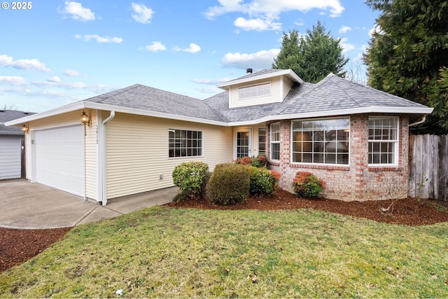 view of front of home with a front yard and a garage