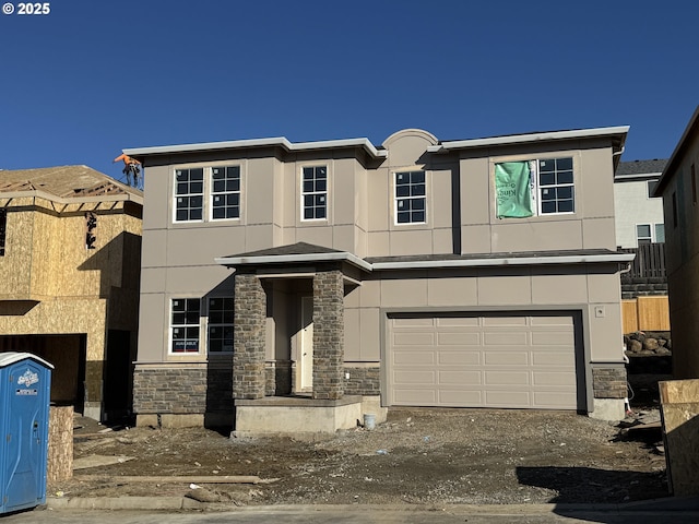 view of front facade featuring dirt driveway, stone siding, a garage, and stucco siding